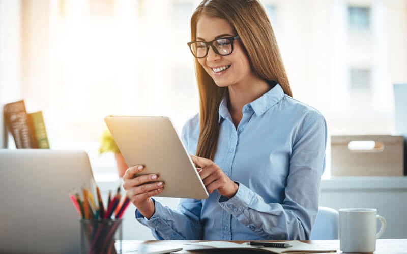 eritas InfoScale Enterprise Woman smiling while using tablet device