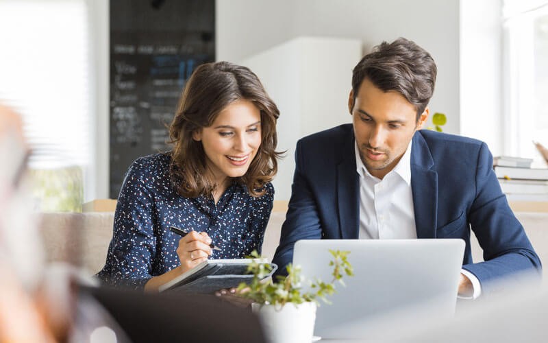 Effective cloud storage Man and woman collaborating over laptop device