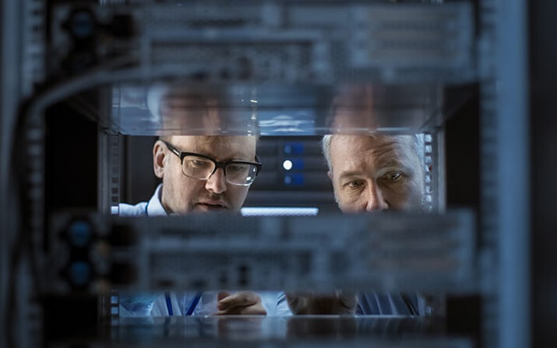 We’ll help you migrate to the right platform IT engineers work between server racks