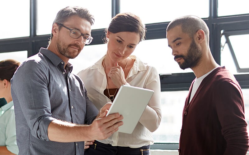 Going to public cloud isn’t always the answer Business professionals gathered around tablet reading IDG Cloud research study