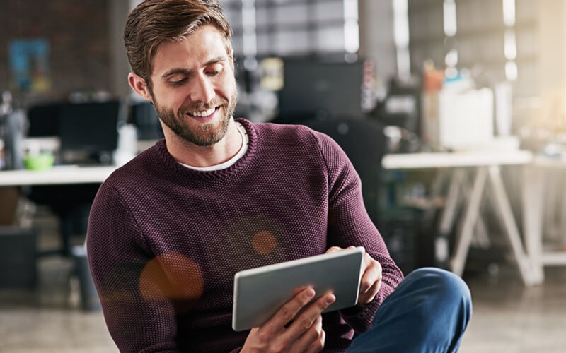 Business professional sitting with tablet in hand as part of the modern workforce