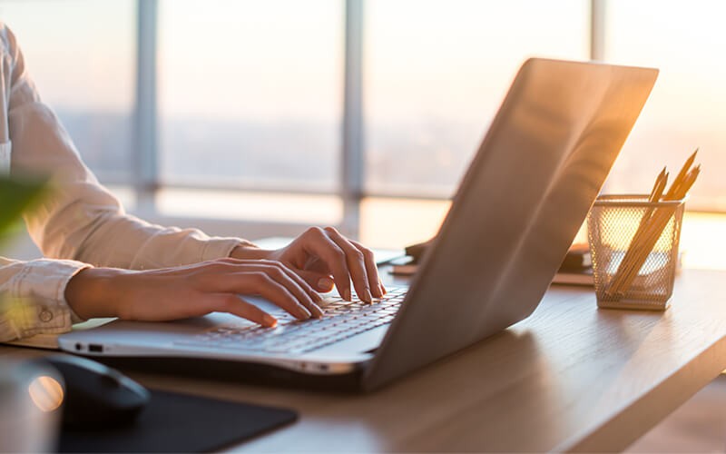 You’ll support a workforce that’s connected and protected Close up of hands typing on laptop keyboard