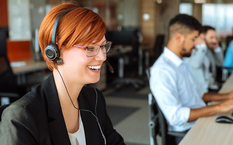 Enhance communication with teammates and customers Smiling woman on headset device