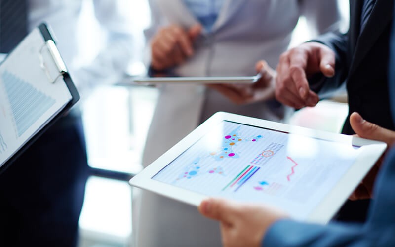 Become the No. 1 trusted source. Group of accountants with statistics on tablet and clipboard