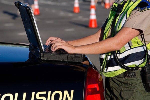A police officer using a laptop