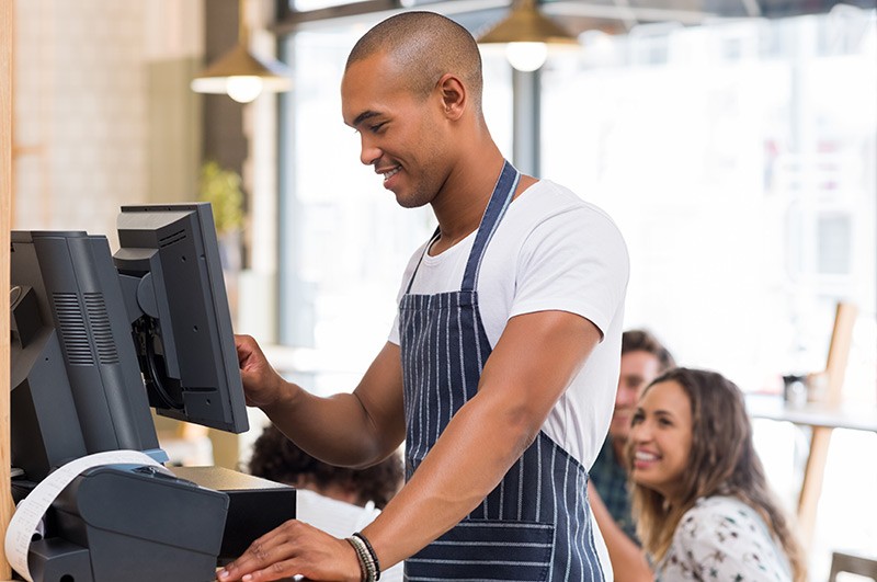 Deliver meaningful value to your business Small business owner using POS system