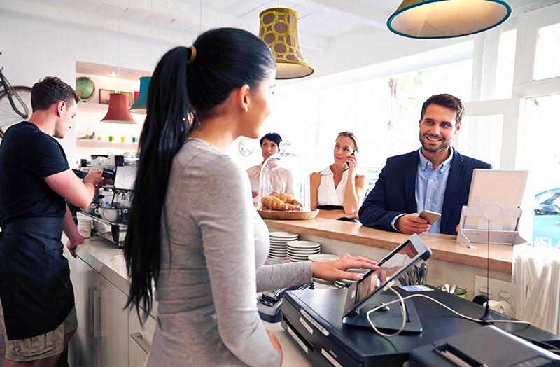 Earn customer loyalty Businessman ordering at cafe