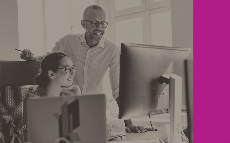 Stay competitive through software solutions. Smiling colleagues use up to date software to complete projects