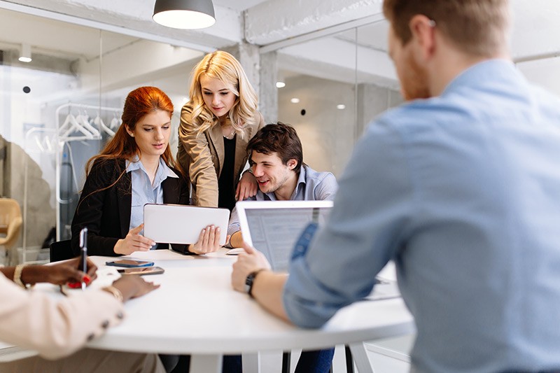 Make smart technology decisions Business professionals brainstorming ideas with various mobile technology in hand