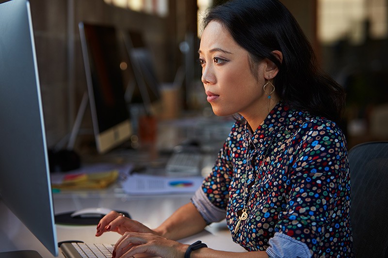 We can coordinate your entire rollout from initial site survey and analysis to end-user support. Business woman works on desktop computer in modern office