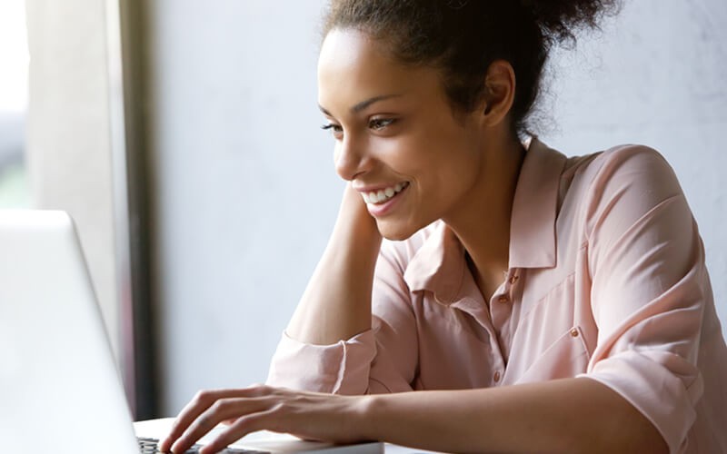 A customizable and easy-to-use web based e-commerce platform. Smiling woman uses an insight.com account to purchase hardware and software