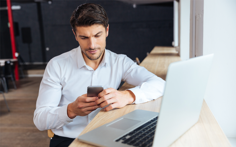 Deeper knowledge of order tracking Businessman reviewing orders on laptop computer and phone