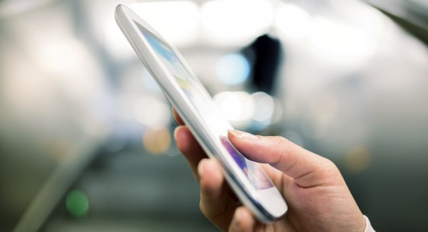 Sign up for electronic invoicing Hand holding smart phone in subway
