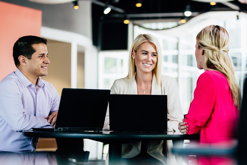 Focus on growing your business. We’ll take care of the rest. Team of business professionals work remotely using Office 365 in cafe.