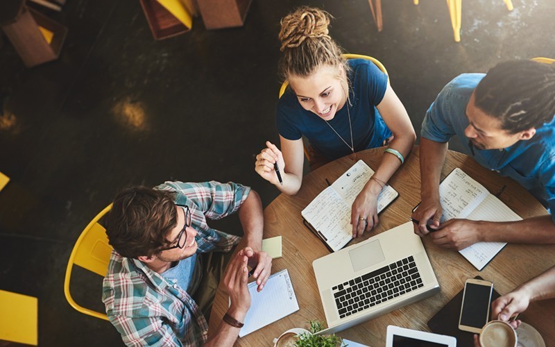 Manage your mobile workforce with ease. Two business colleagues use mobile tablet device