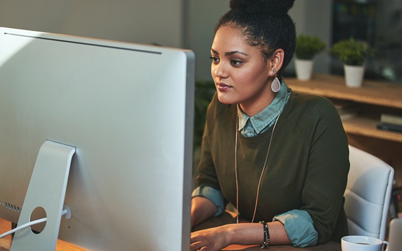 Leverage our deep management knowledge Businesswoman on desktop computer